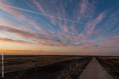 Weites Moorland mit ziehenden Wolken kurz vor Sonnenuntergang photo