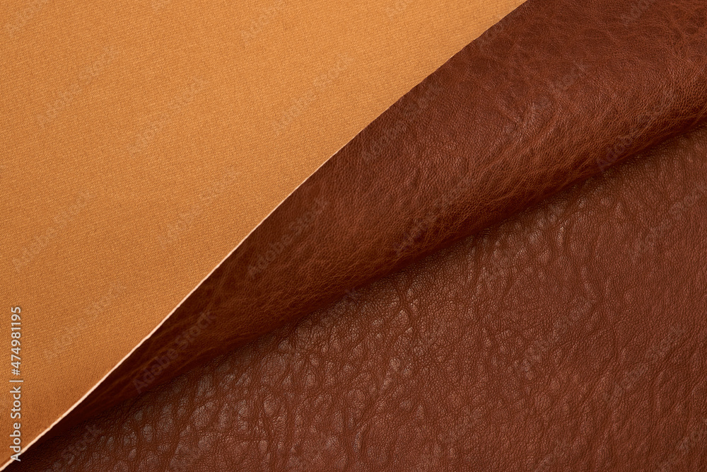 Fototapeta premium brown artificial leather with waves and folds on PVC base