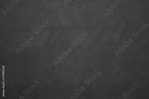 black artificial leather with waves and folds on PVC base