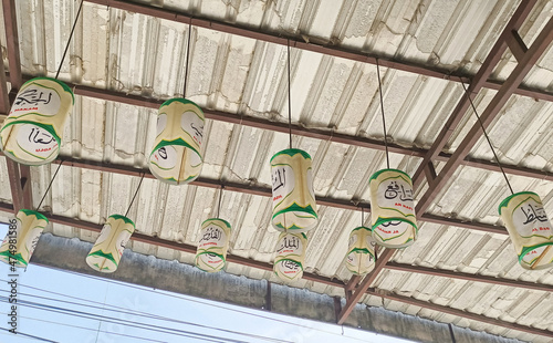 Sukoharjo - December 13,2021 : lots of paper lanterns hanging on the iron roof photo