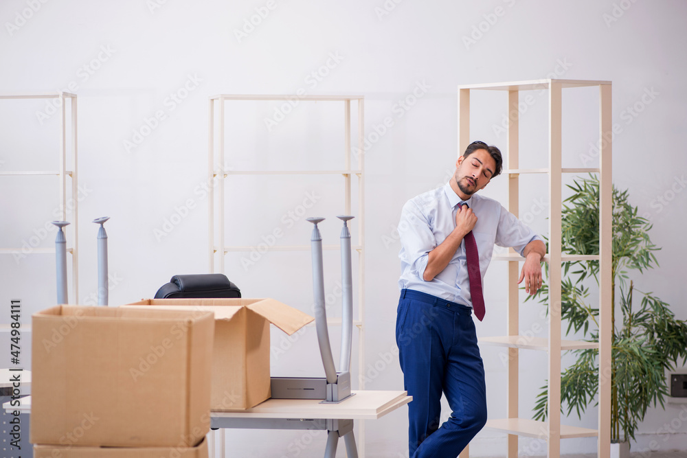 Young male employee in relocation concept Young male employee in relocation concept