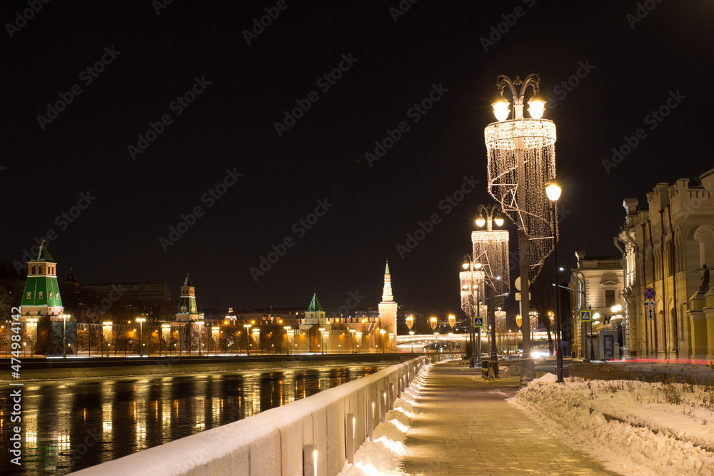 Moscow, Russia.  Winter at Sofiyskaya embankment. December. Lanterns. The Moscow Kremlin towers in background