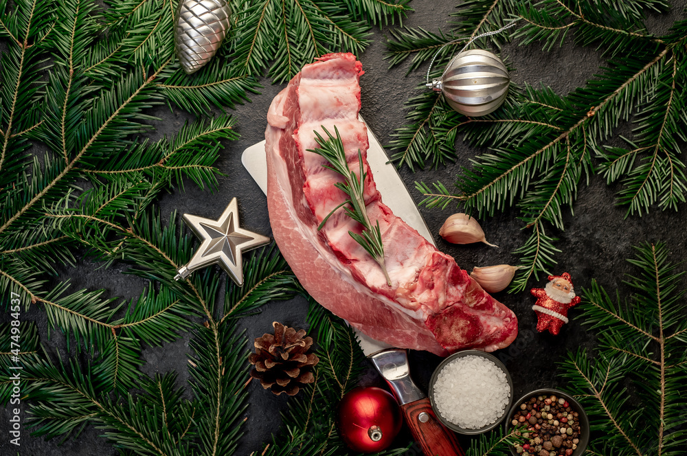 Christmas raw pork ribs on a stone background with spruce and christmas