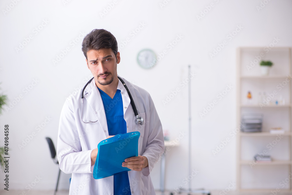 Young male doctor working in the clinic Young male doctor working in the clinic