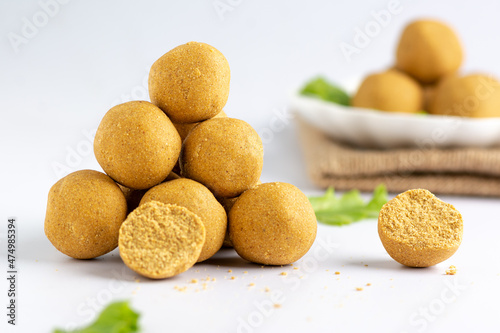 Stack of Dankwa   maize-peanut balls  snack Hausa delicacy with lettuce  isolated against a white background