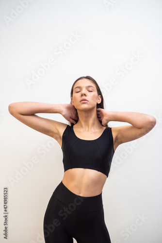 High fashion portrait of young fit elegant woman wearing black clothes.  © alipko