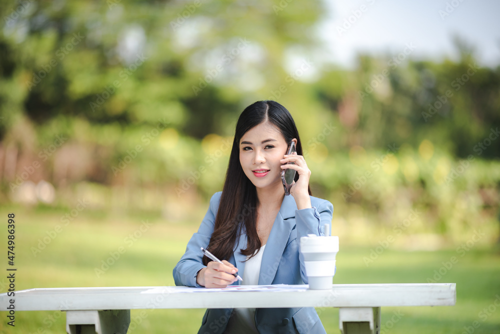 young Asian business woman working outdoor with online cyberspace communication, happy lifestyle young Asian business woman working outdoor with online cyberspace communication, happy lifestyle