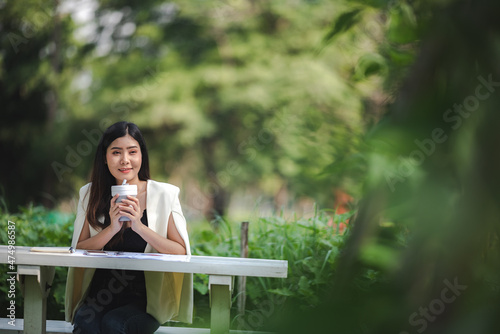 young Asian business woman working outdoor with online cyberspace communication, happy lifestyle