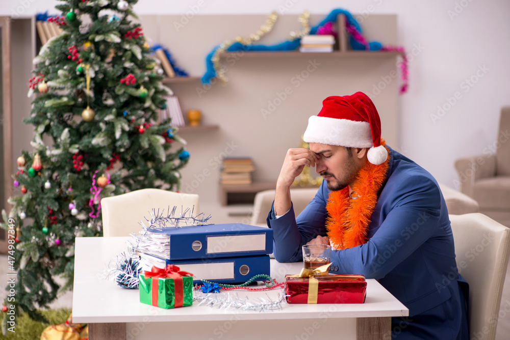 Young businessman working from home at Christmas eve Young businessman working from home at Christmas eve