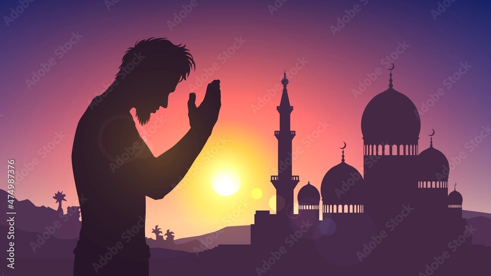 Silhouette of a mosque and a praying man on the background of sunset or dawn