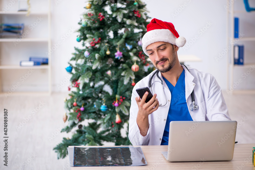 Young male doctor celebrating Christmas at the hospital Young male doctor celebrating Christmas at the hospital