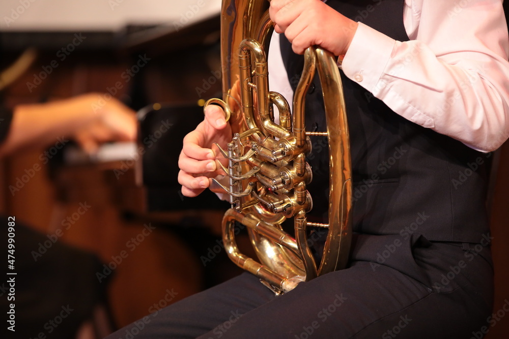 Fototapeta premium Student playing tuba in music class.The concept of music education and school development of children