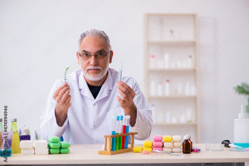 Old male chemist testing soap in the lab Old male chemist testing soap in the lab