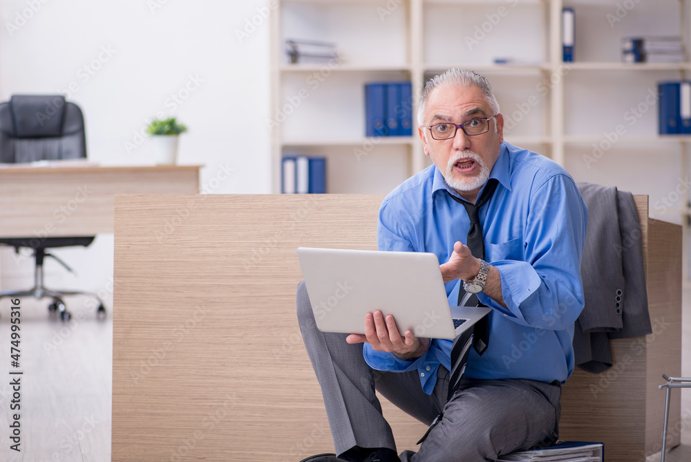 Old male employee unhappy with excessive work in the office Old male employee unhappy with excessive work in the office