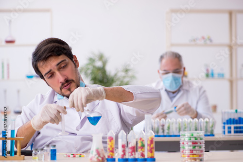 Two male chemists in drugs synthesis concept at the lab