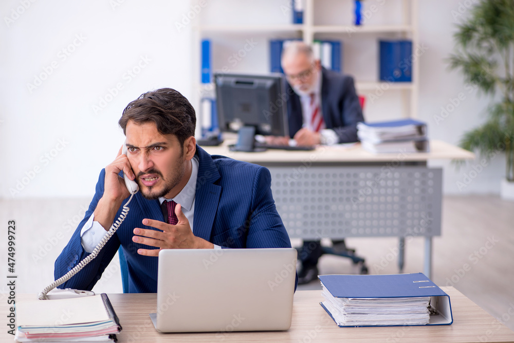 Two male colleagues working in the office Two male colleagues working in the office