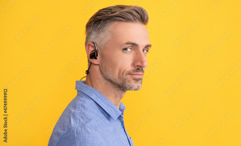 mature unshaven guy. agile business. handsome man with wireless headphones. mature unshaven guy. agile business. handsome man with wireless headphones.