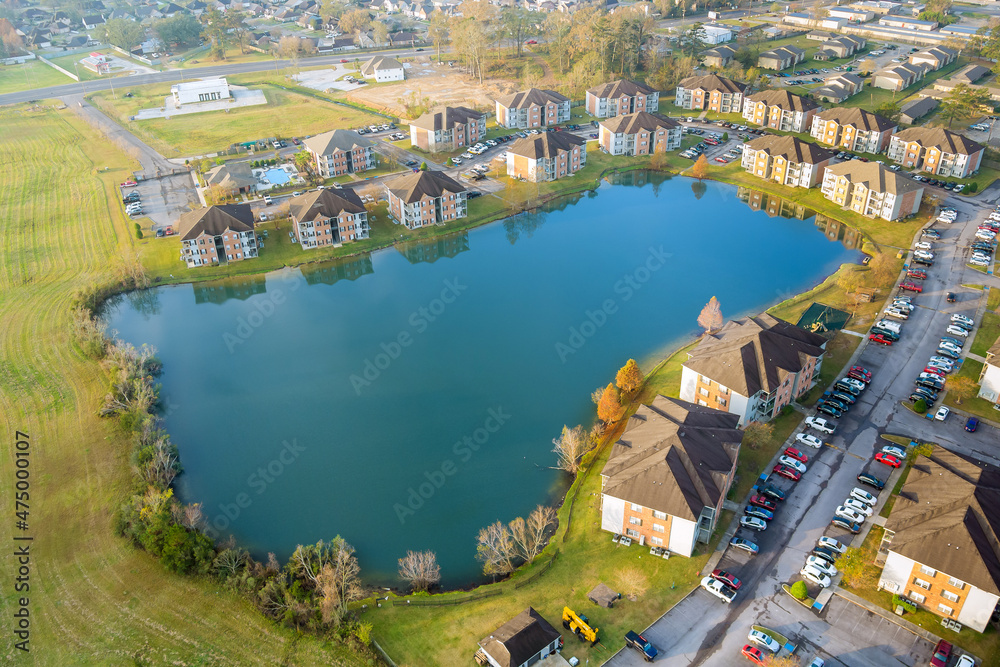 Aerial autumn scene the Denham Springs small town apartment complex near pond in Louisiana USA