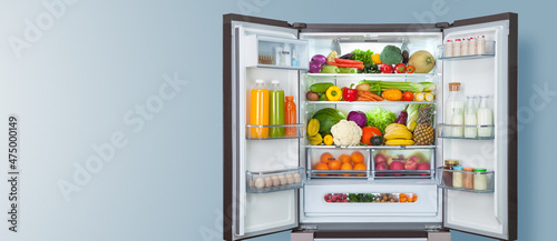 Tableau sur toile different fruits and vegetables in a open fridge