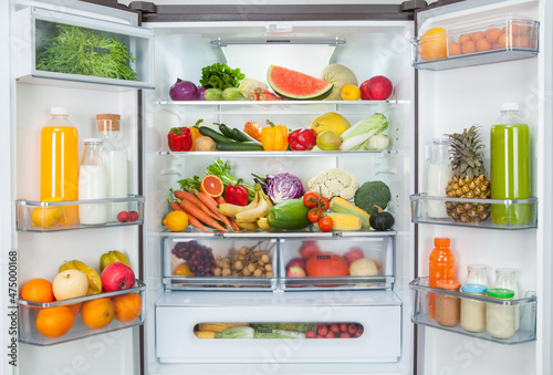 open fridge with fresh fruits and vegetables. refrigerator with healthy food. photo