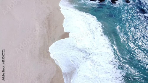 4k Aerial view of Beach coast with waves rushing the shoreline 