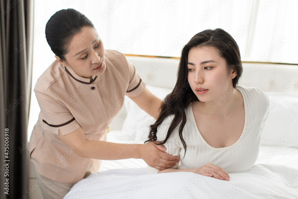 Confinement nurse taking care of young woman Confinement nurse taking care of young woman