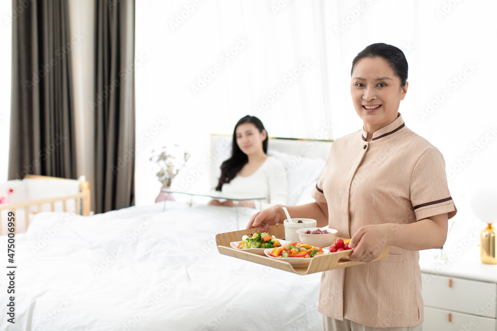 Confinement nurse taking care of young woman Confinement nurse taking care of young woman