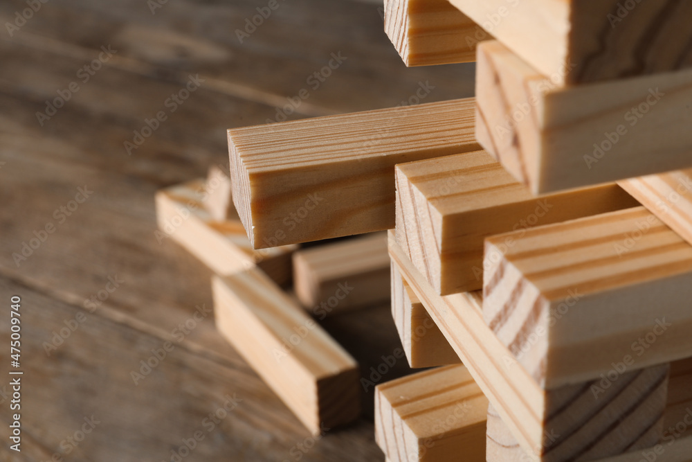 Jenga tower made of wooden blocks on table, closeup. Space for text