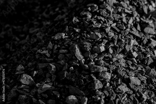 Coal. Combustible sedimentary rocks are brown to black in color. Caused by the accumulation of natural plant remains.