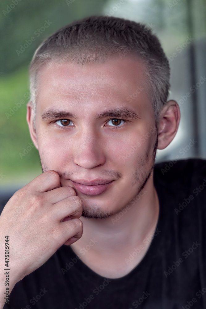 Obraz premium Portrait of a serious guy with gray hair wearing a black T-shirt