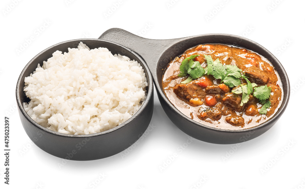 Frying pan with tasty beef curry and rice in bowl on white background Frying pan with tasty beef curry and rice in bowl on white background