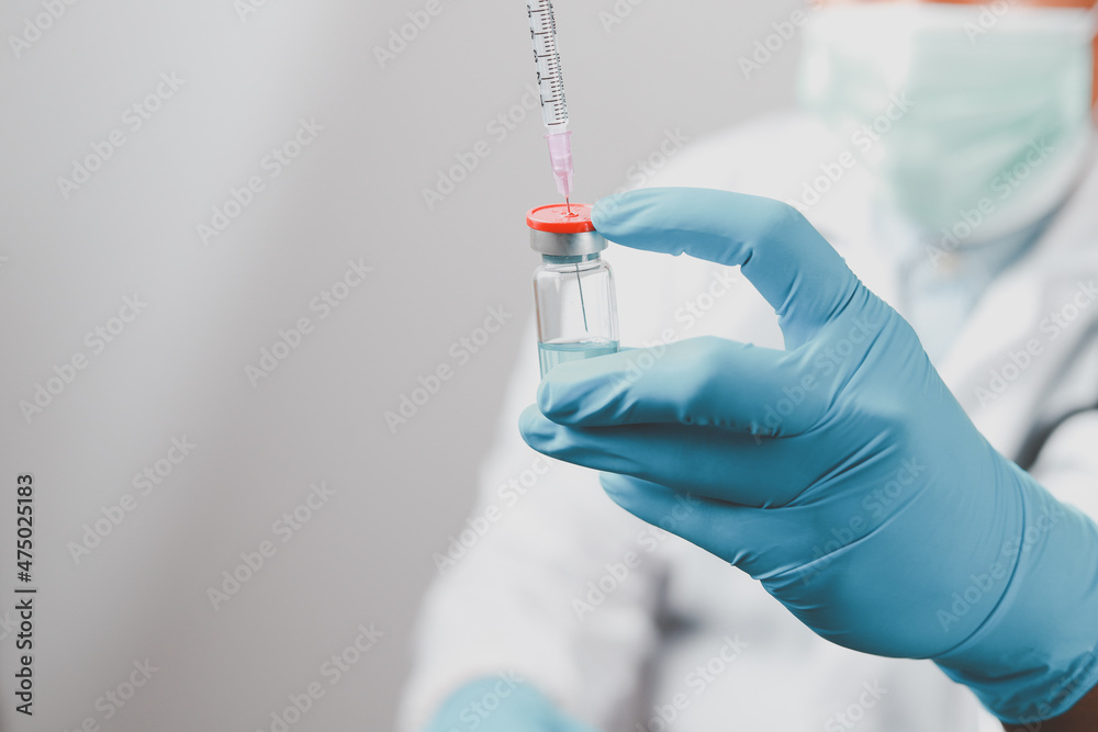 A doctor or scientist in the COVID-19 medical vaccine research and development laboratory holds a syringe with a liquid vaccine to study and analyze antibody samples for the patient.
A doctor or scientist in the COVID-19 medical vaccine research and development laboratory holds a syringe with a liquid vaccine to study and analyze antibody samples for the patient.