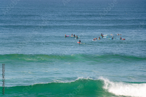 Surfers waiting for a wave in the ocean at Cronulla, NSW, Australia. photo