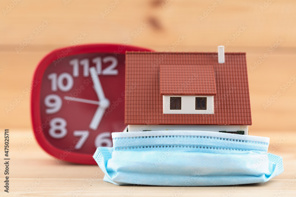 A model house with a mask and an alarm clock
