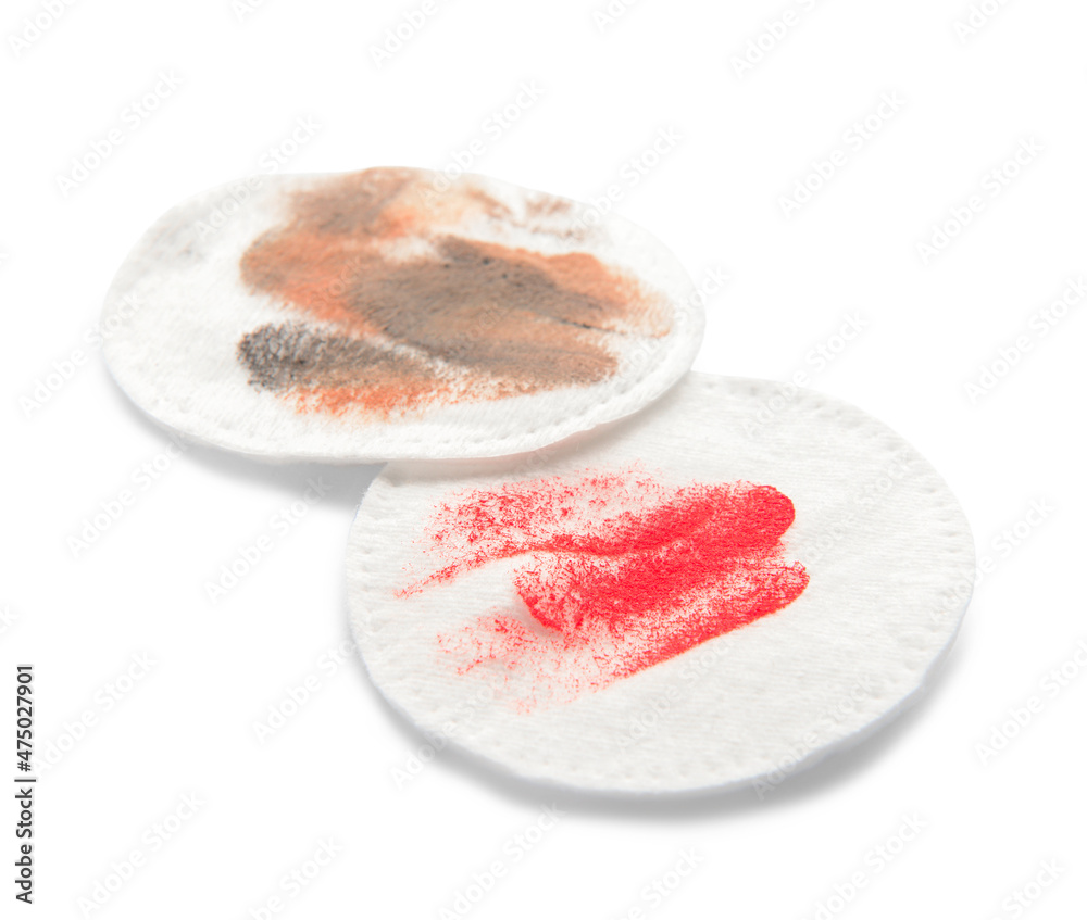 Dirty cotton pads after removing makeup on white background