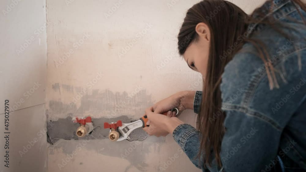 a beautiful young woman makes repairs at home