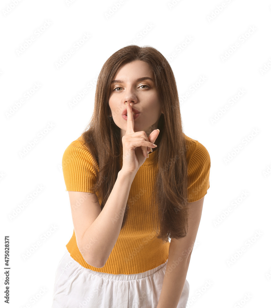Young woman showing silence gesture on white background Young woman showing silence gesture on white background