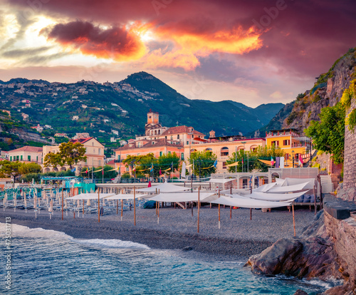 Picturesque summer cityscape of Minori town.  Incredible sunset on Mediterranean cost. Amazing evening scene of Italy, Salerno region, Europe. Vacation concept background.