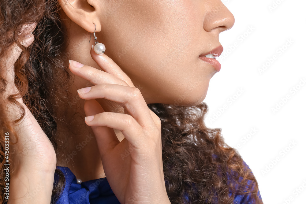 Fashionable African-American woman with stylish jewellery on white background, closeup