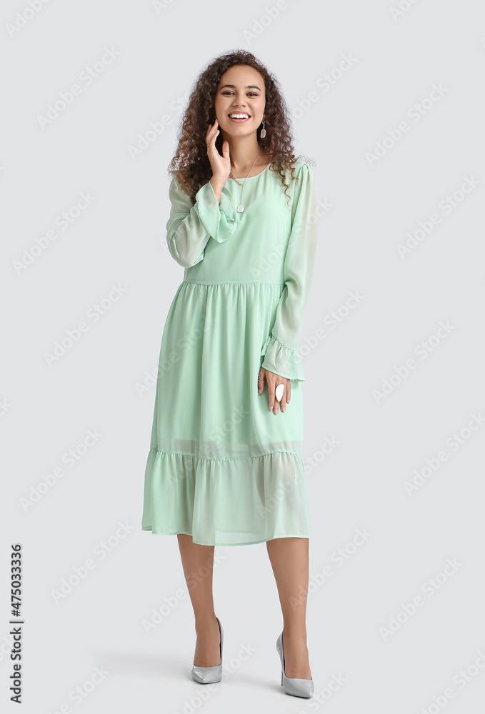 Fashionable African-American woman on light background Fashionable African-American woman on light background