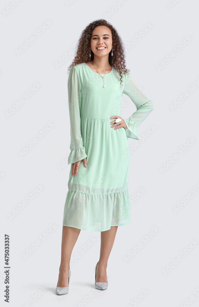 Fashionable African-American woman on light background Fashionable African-American woman on light background