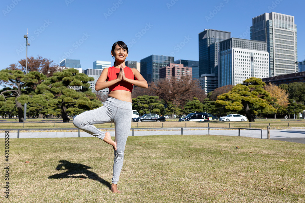 A healthy woman does yoga exercises in the morning