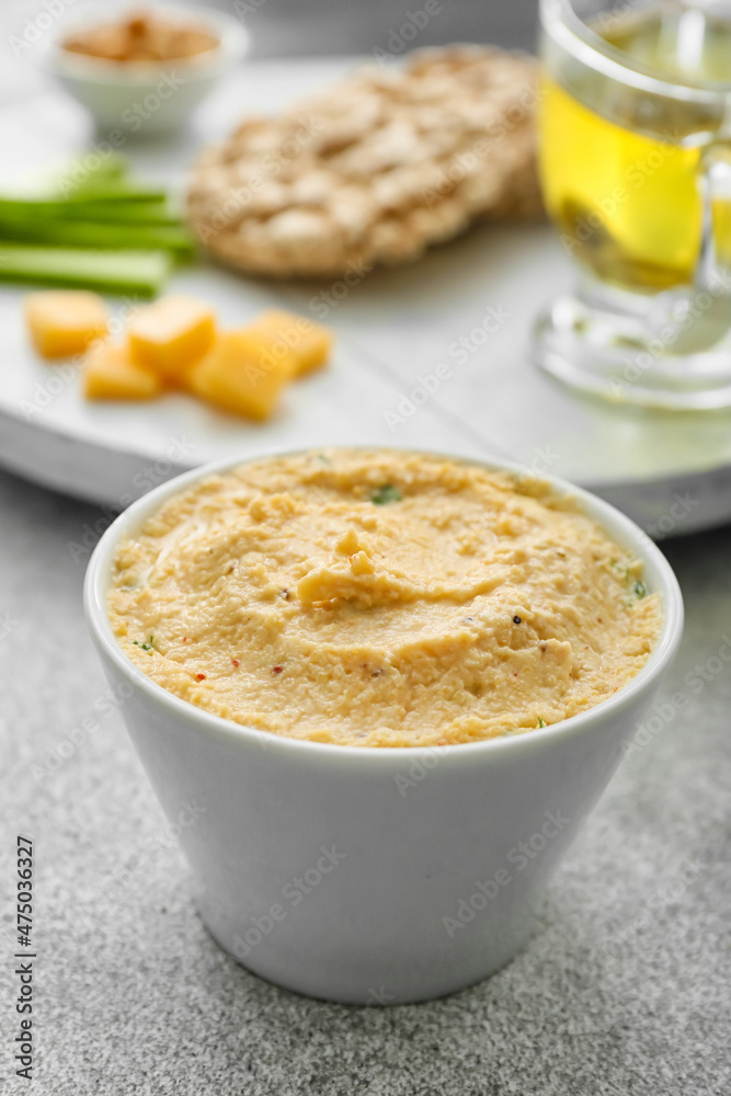 Bowl with delicious hummus on table, closeup Bowl with delicious hummus on table, closeup