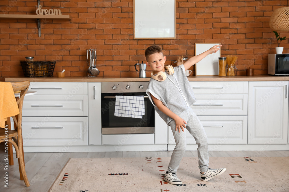 Cute little boy dancing in kitchen