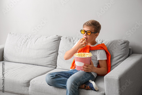 Little boy in eyeglasses ea...