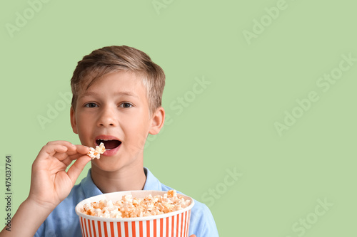 Little boy eating tasty pop...