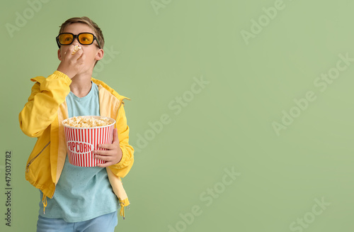 Little boy in eyeglasses ea...