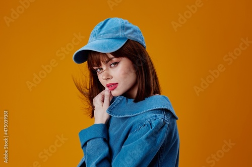 Pretty young female stylish denim clothing posing color background unaltered