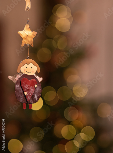 Painted angel symbol in front of a Christmas tree
