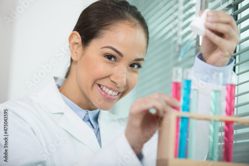 happy scientist making observation of the bottle of chemical